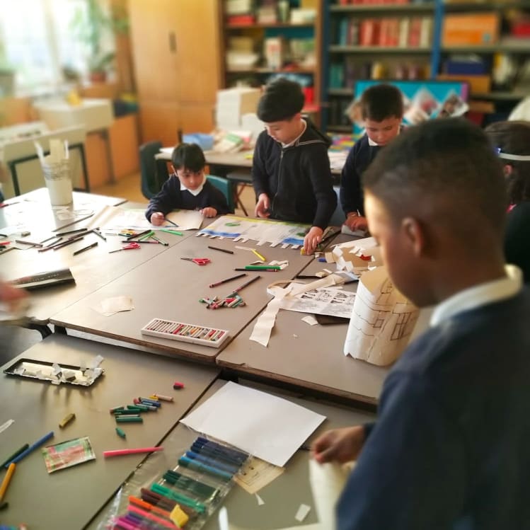 Young people at a school desk doing some activities